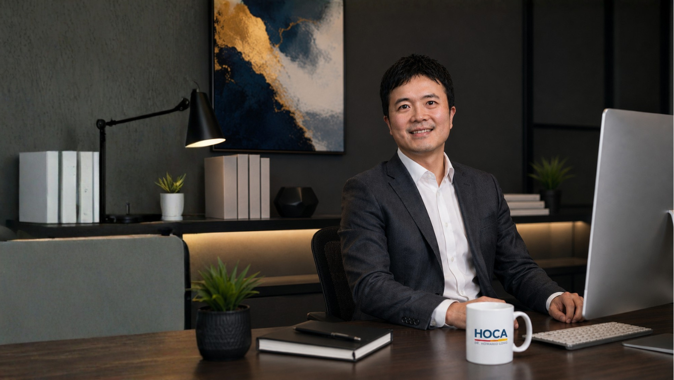 Dr Howard Long at his Auckland office desk with a HOCA mug